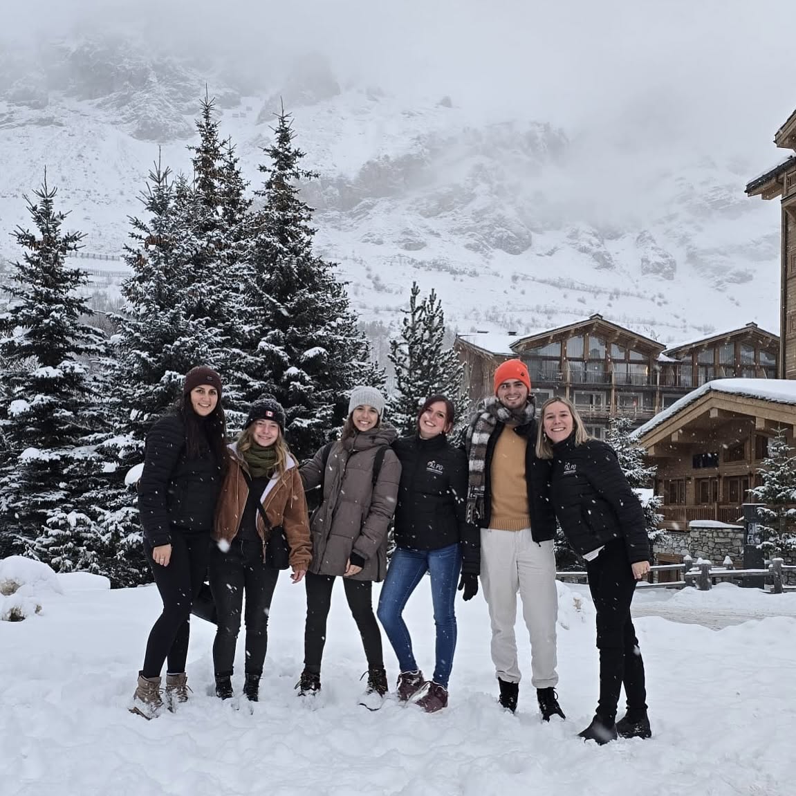 L'équipe ALPO Conciergerie sous la neige, devant les chalets de la station
